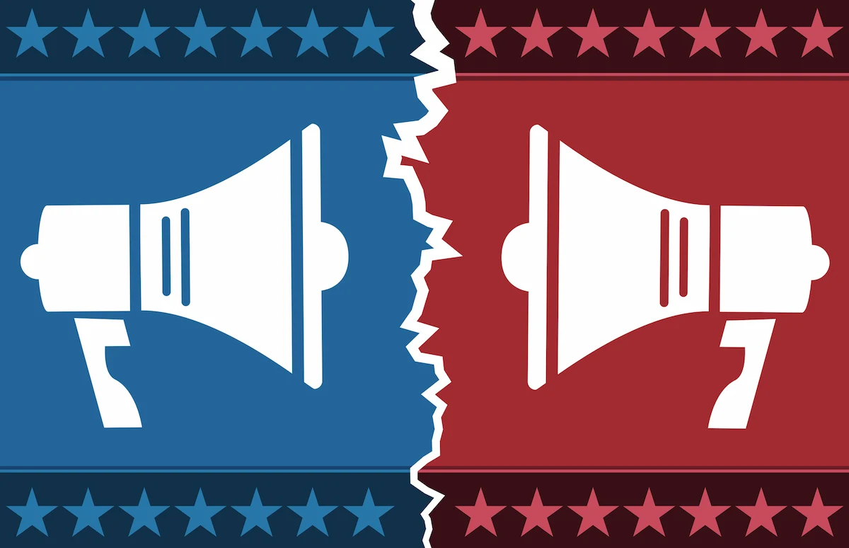 Two white megaphones on a background split by a jagged tear. The left is blue, the right is red, both with star borders.