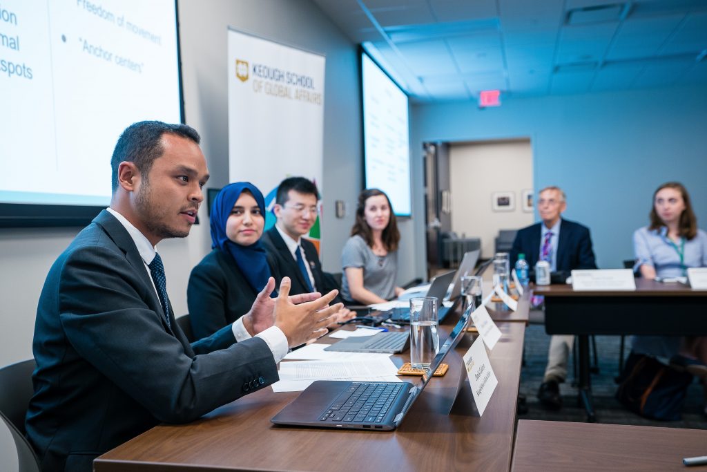 Students present to a roundtable of immigration experts