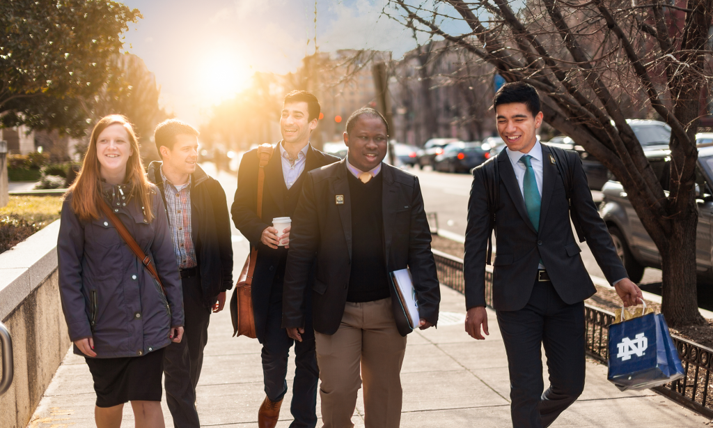 Five students walk alongside each other on a street in Washington, DC