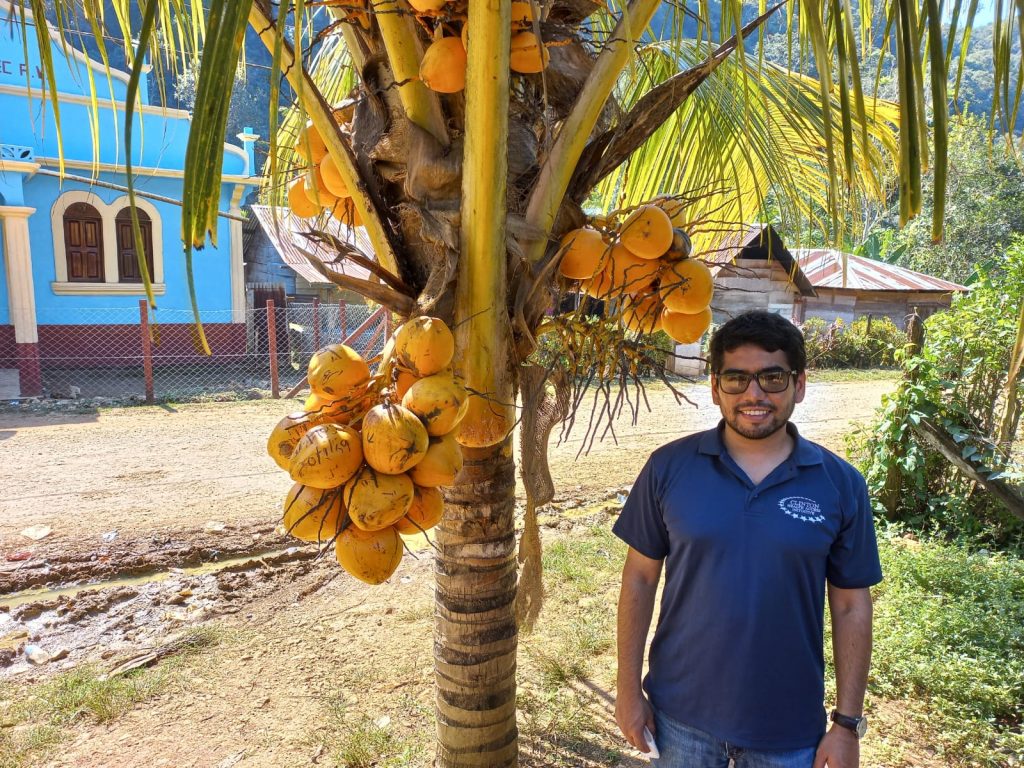 Photo of Hugo Flores Navarro next to a mango tree in Semax, Guatemala.