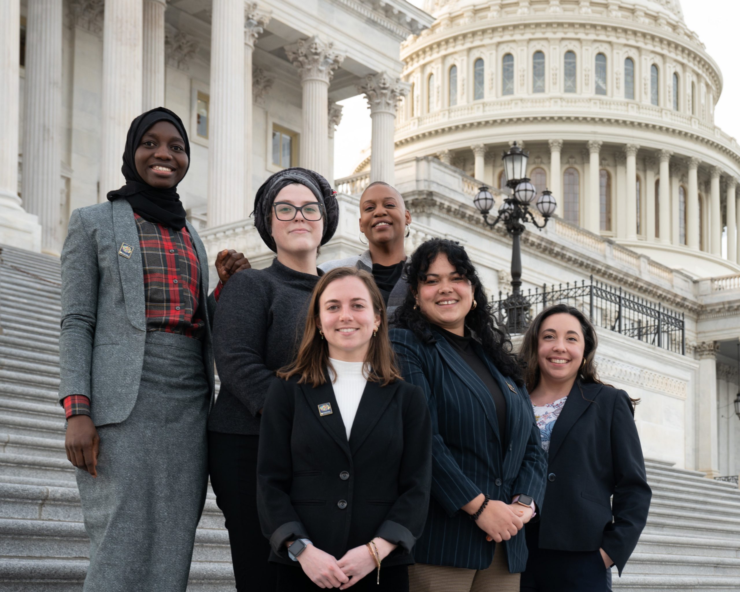 Six women standing on the steps of the US Capitol building.