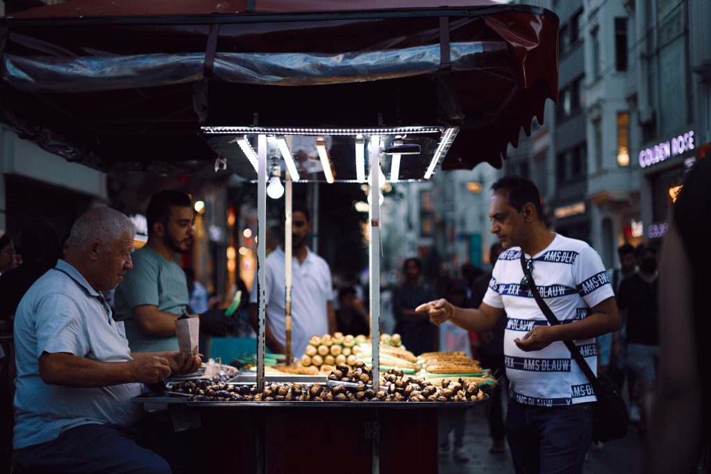 A group of men buy and sell produce in a market