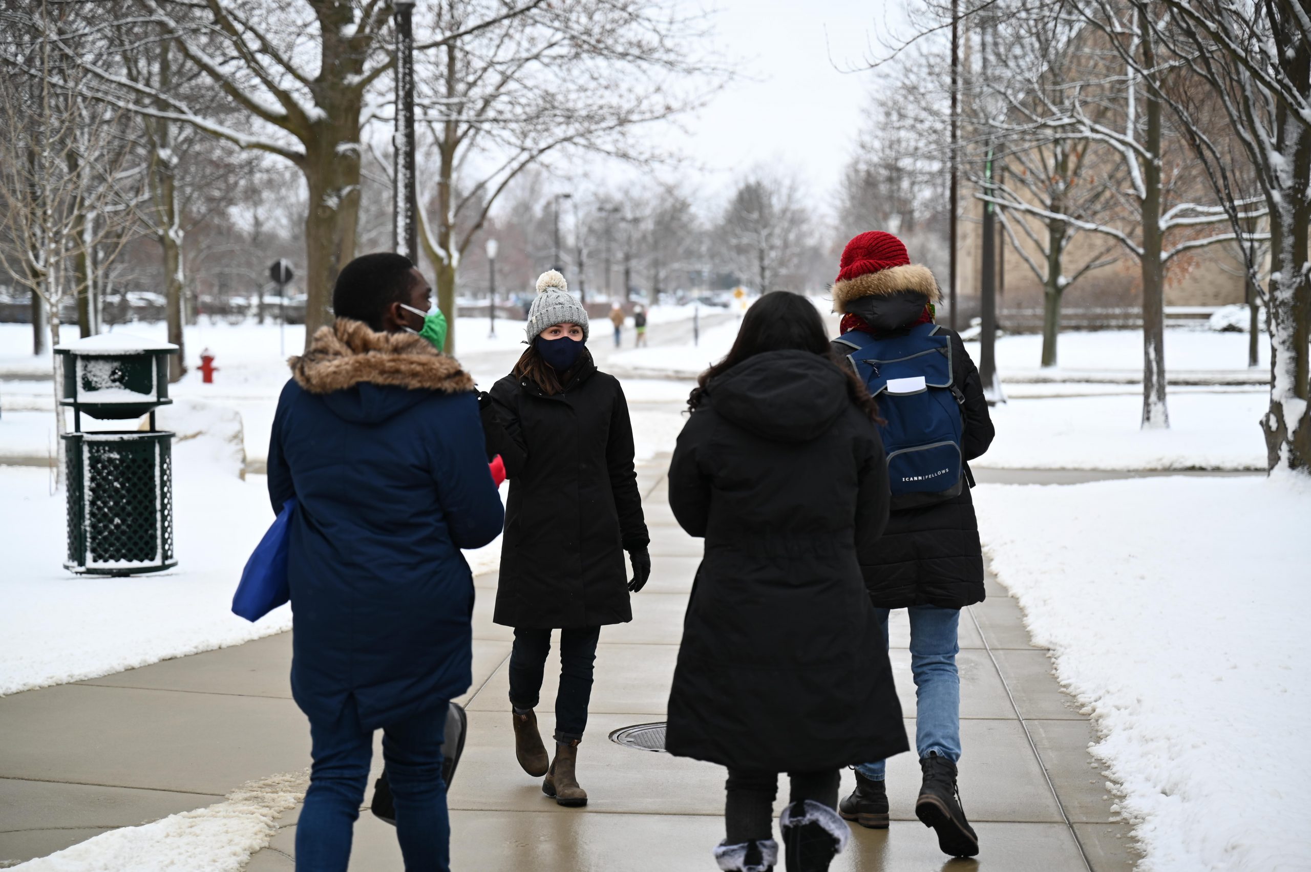 Students on a Notre Dame campus tour in the snow