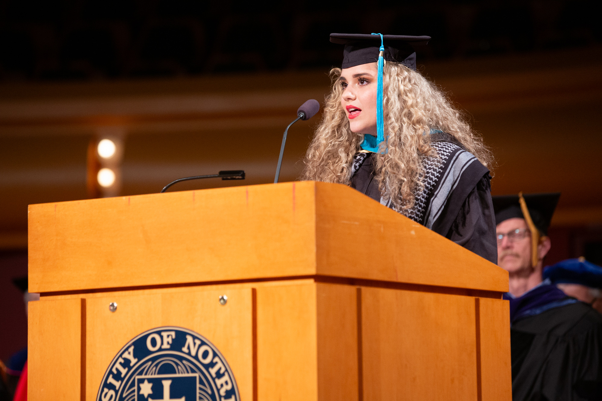 Photo of student Renée Perez speaking at lectuern