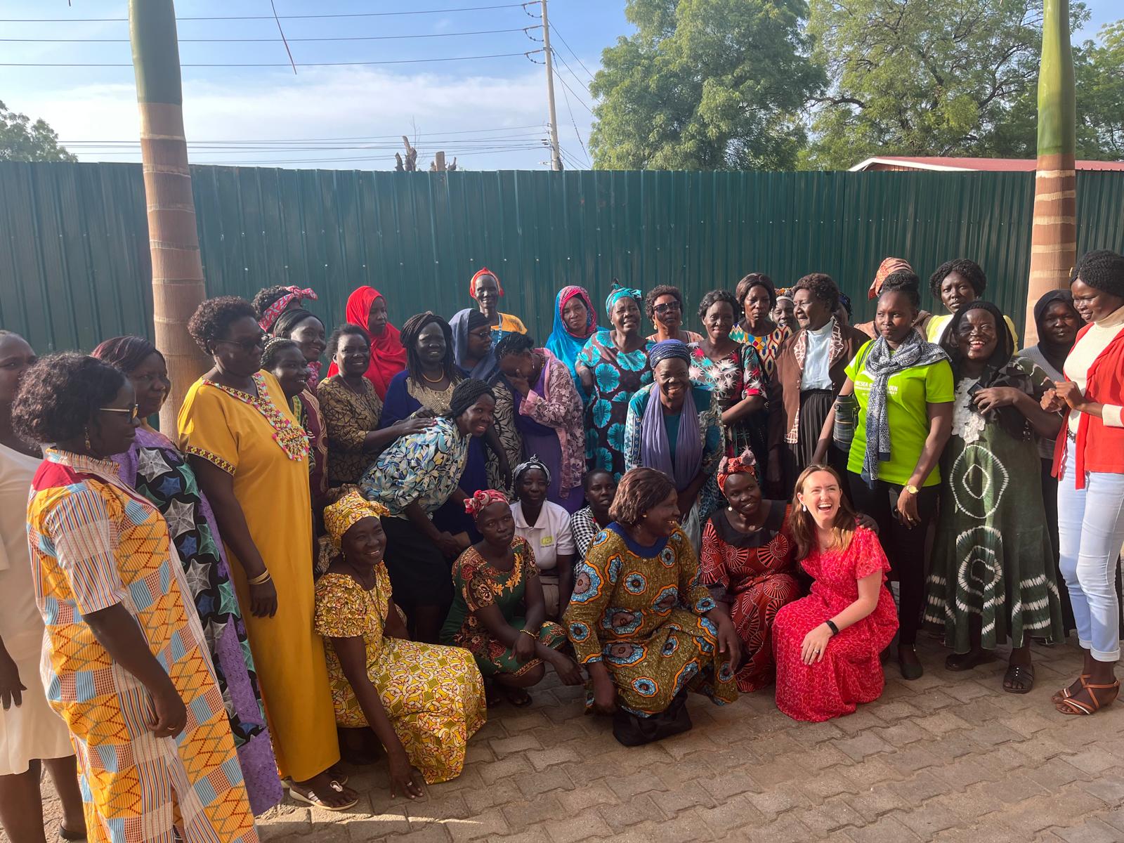 Elizabeth Boyle MGA '23, BA '20 (seated, in red dress) with members of the South Sudan Council of Churches Womanlink group in Juba, South Sudan.